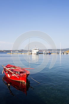 Red fishing boats anchored in the sea. Harbor Ammouliani, small island in Greece