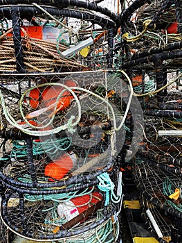 Red fishing buoys in a stack of crab traps