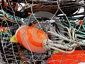 Red fishing buoys in a stack of crab traps