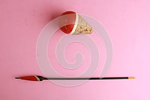 Red fishing float isolated on pink background