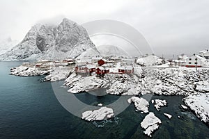 Red fishing hut (rorbu) on the Hamnoy island in winter, Reine, L