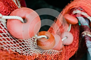 Red fishing net floats in a line
