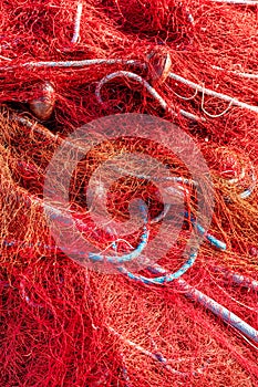 Red fishing nets with floats and ropes. Close-up shot, perfect image for fishing, aquaculture and environmental protection