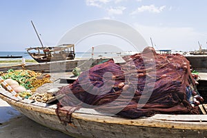 Red fishing nets on a wooden boat