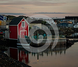 Red fishing shack reflecting in the water
