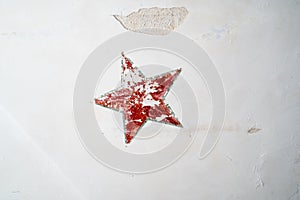 Red five-pointed star on the old wall