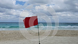 Red flag Alert, warning dangerous to swimming in sea. Red flag flying on beach with sound of winds and sea waves.