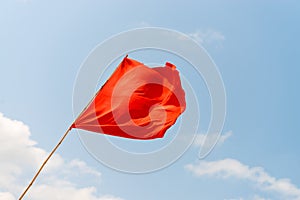 Red flag on the beach. Warning about the dangers