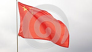Red flag of China with five golden stars symbolizing Communist Revolution and unity of Chinese people under leadership