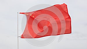 Red flag of China with five golden stars symbolizing Communist Revolution and unity of Chinese people under leadership