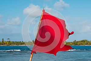 Red flag ocean background - beach warning symbol