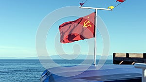 Red flag of the Soviet Union on the ship.