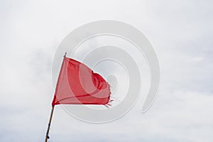 Red flag warning flags wind blue sky