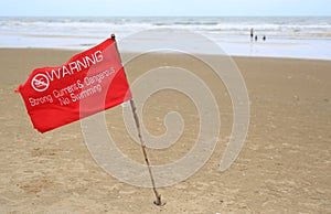 Red flag Warning Strong Current and Dangerous No Swimming in sea on Storm. Red flag flying on beach