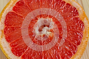 Red flesh of grapefruit close-up. Half of grapefruit, fresh citrus. Texture. Sour ripe juicy fruit