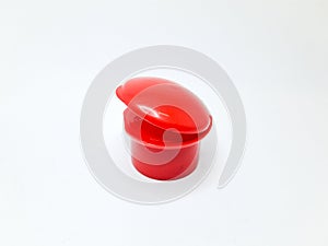 red fliptop type plastic bottle cap, isolated on white background