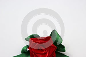 Red rose with green petals made by hand from satin ribbon