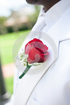 Red flower on lapel of groom photo