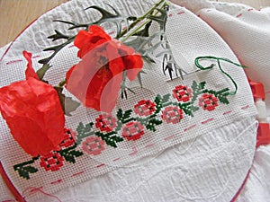 Red flower motiv hand embroidery on white and poppy flowers