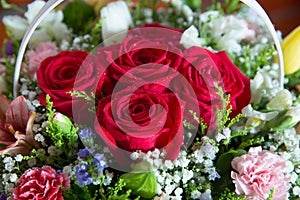 Red flower picture close up in the bouquet. The flower`s petal . Bouquet of fresh red, white , orange roses . bouquet of