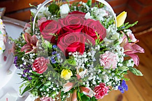 Red flower picture close up in the bouquet. The flower`s petal . Bouquet of fresh red, white , orange roses . bouquet of