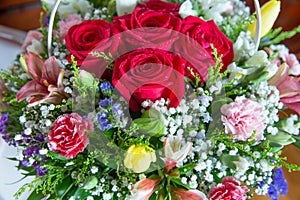 Red flower picture close up in the bouquet. The flower`s petal . Bouquet of fresh red, white , orange roses . bouquet of