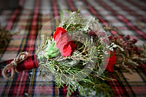 Red Flowers with evergreen and holly berries