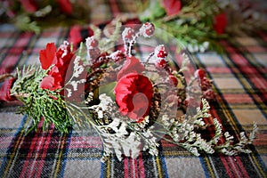 Red Flowers with evergreen and holly berries