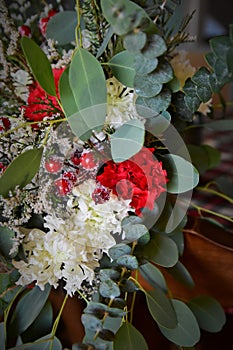 Red Flowers with evergreen and holly berries