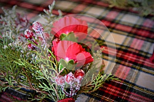 Red Flowers with evergreen and holly berries