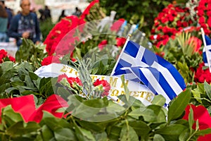 Red flowers and greek flags to conmemorate the 46th aniversary of the uprising students against the Greek junta in 1973. photo