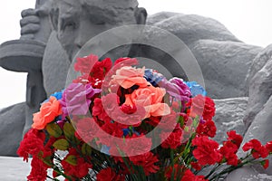 Red flowers at the monument to the fallen Soviet soldiers of the Brest Fortress. May 9.