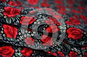 Red flowers seamless pattern on black fabric background.