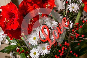 Red flowers with wooden sign Love