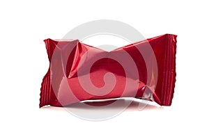 A Red Foil Wrapped Chocolate Truffles on a White Background