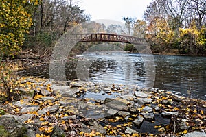 Red footbridge over the Tulpehocken Creek in autumn