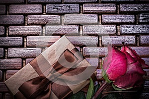 Red fragrant rose wrapped gift box on wicker