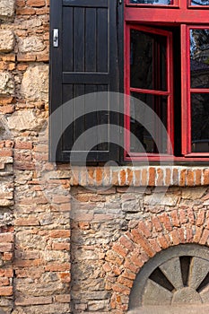 Red frame window on a brick wall