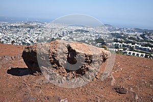 A red Franciscan rock with a view of the city below, 1.