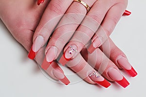 Red french nail art with rhinestones photo