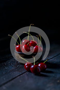 Red and fresh cherries on wooden background