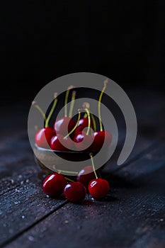 Red and fresh cherries on wooden background