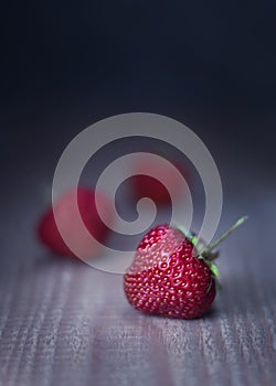 Red fresh strawberries on wooden dark background, rustic style,