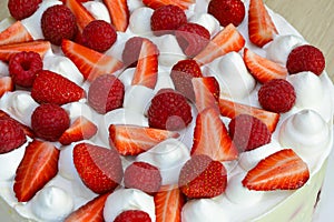 Red fresh strawberry, raspberries in white sweet photo