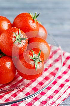 Red fresh tomatoes on trasparent dish