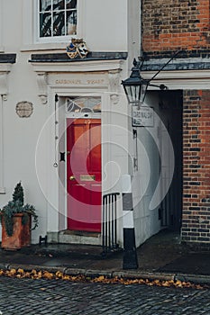 Red front door of a traditional English terraced house in Cardinals wharf, London, UK