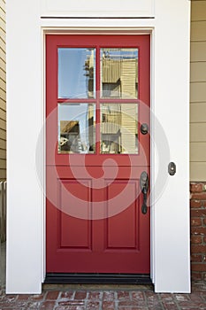 Red front door on an upscale home photo