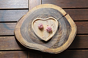 Red fruit brigadiers on a heart-shaped plate. photo