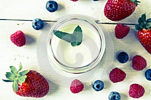 Red fruit compote with mint leaves and fruit