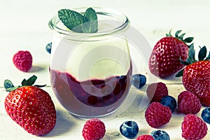 Red fruit compote with mint leaves and fruit